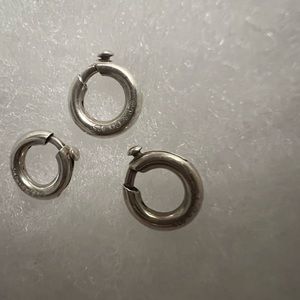 Three retired circle Tiffany & Co. charm clasps